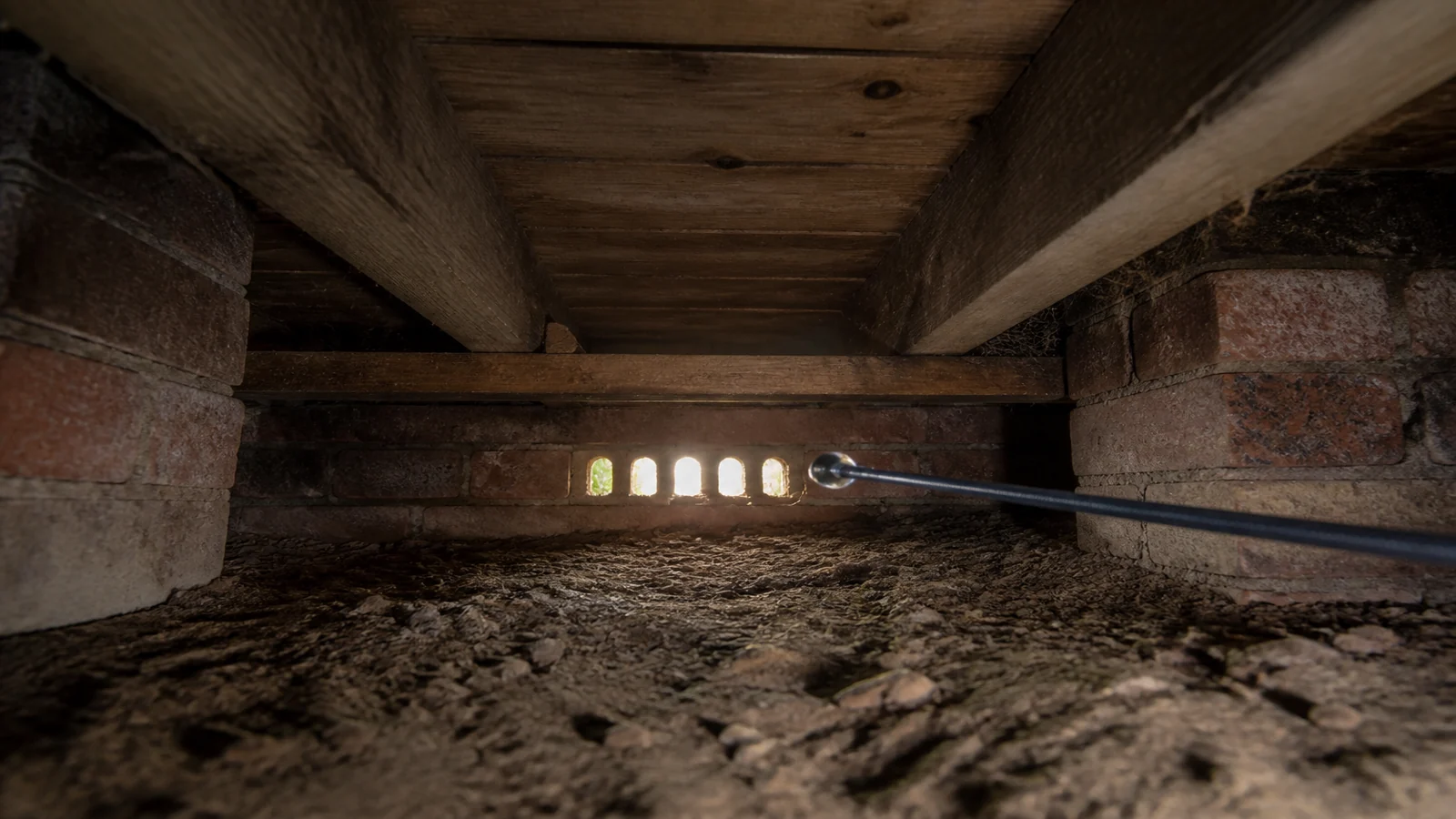 Inspection camera viewing joists beneath a suspended timber floor